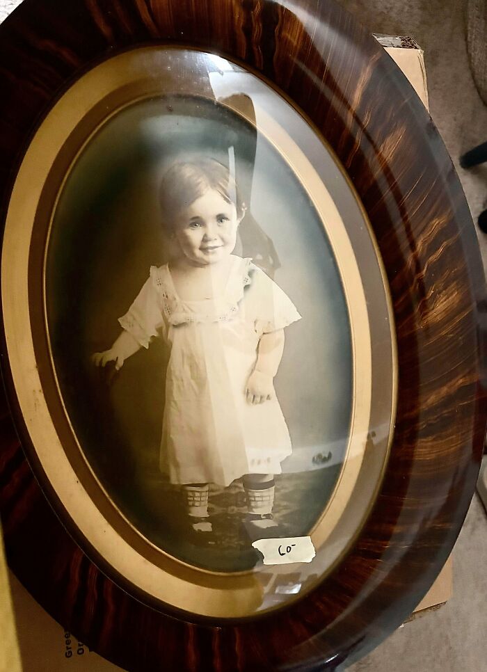Old portrait framed in a dark wood oval frame showing old treasures discovered by antique lovers.
