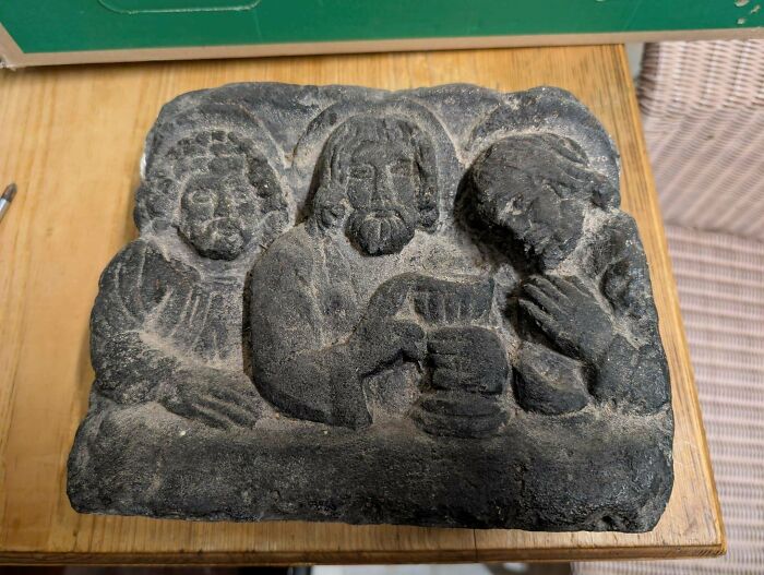 A carved stone relief depicting figures, part of old treasures discovered by antique lovers