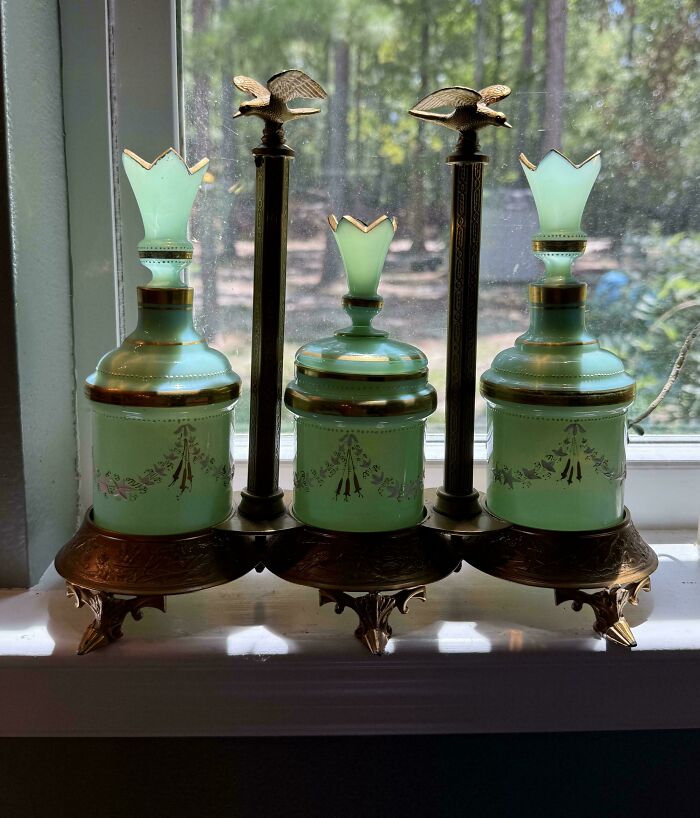 A set of green glass vanity bottles with gold trim, an example of old treasures discovered by antique lovers