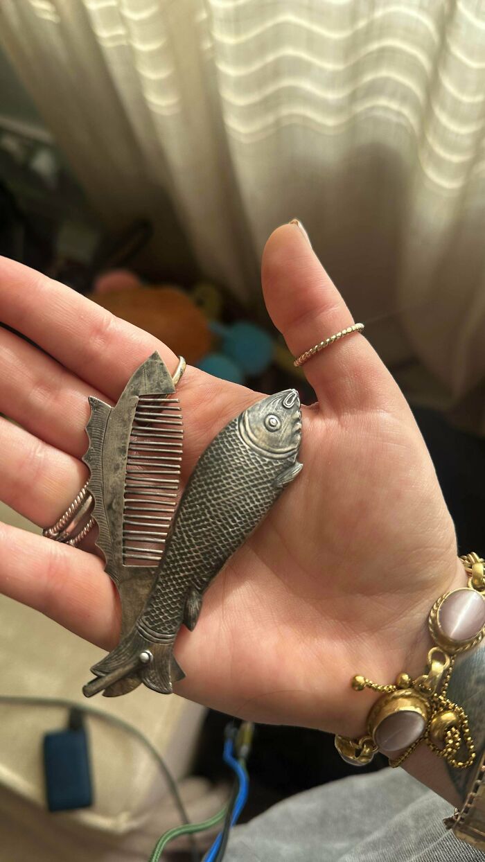 Unique silver fish-shaped folding pocket comb, ideal for antique lovers collecting old treasures.