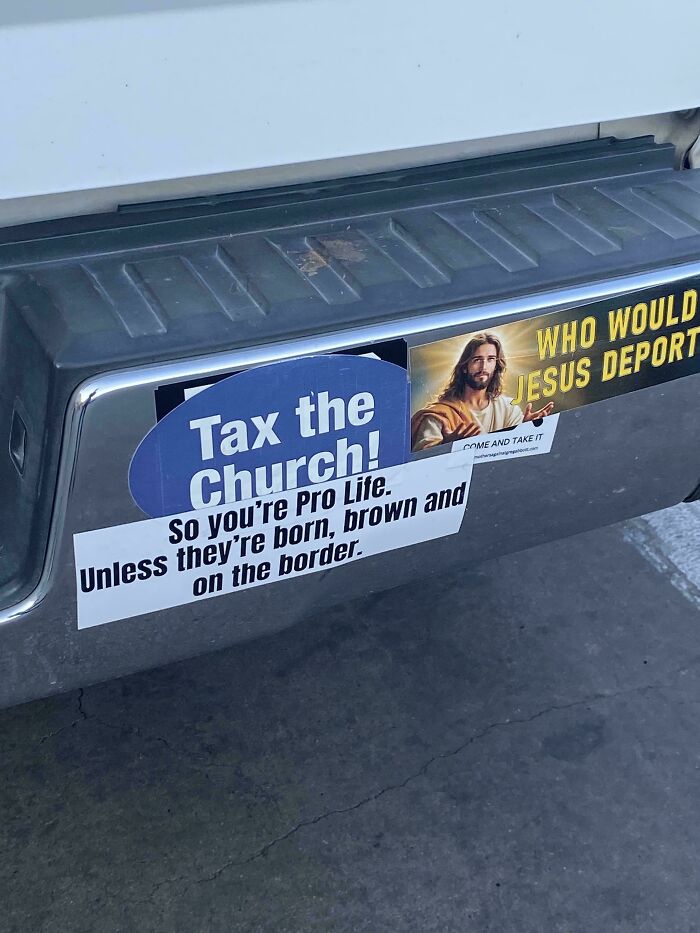 Car bumper displaying political and religious wild bumper stickers on a vehicle.