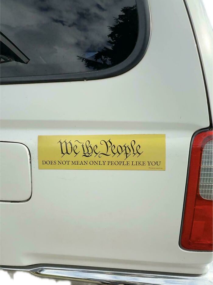 Yellow wild bumper sticker on a white vehicle discussing We the People.