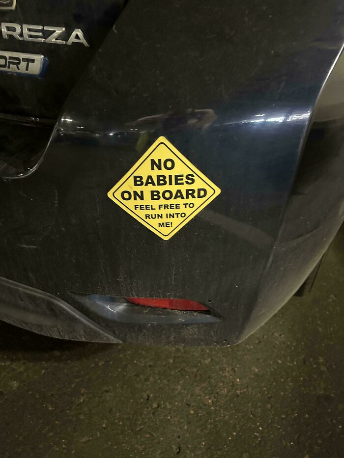 Yellow diamond-shaped bumper sticker on a vehicle bumper reading No Babies On Board, showcasing wild bumper stickers.