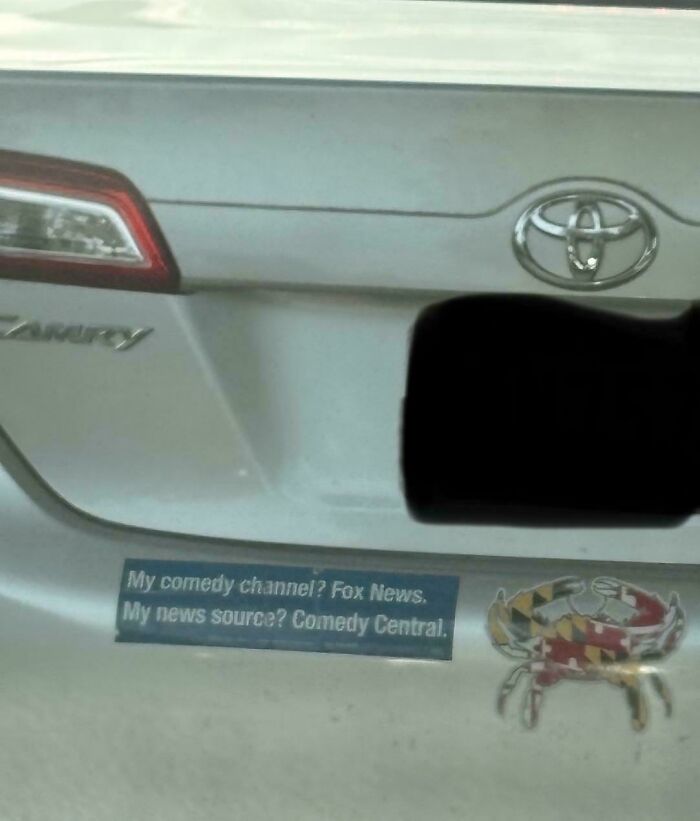 A humorous bumper sticker on a car stating My comedy channel? Fox News. My news source? Comedy Central.