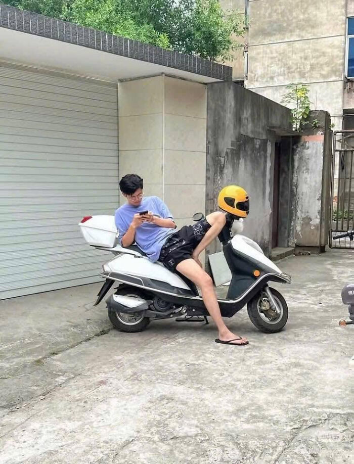 Person sitting on a scooter blending with a yellow helmet creating a visual illusion