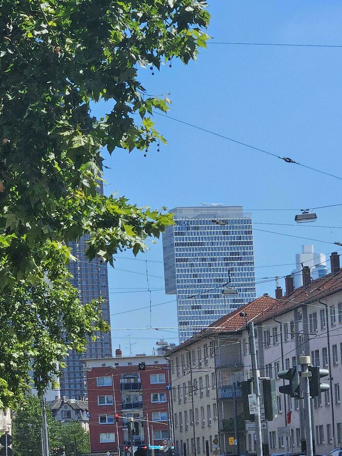Urban street with buildings and a skyscraper with a floating appearance