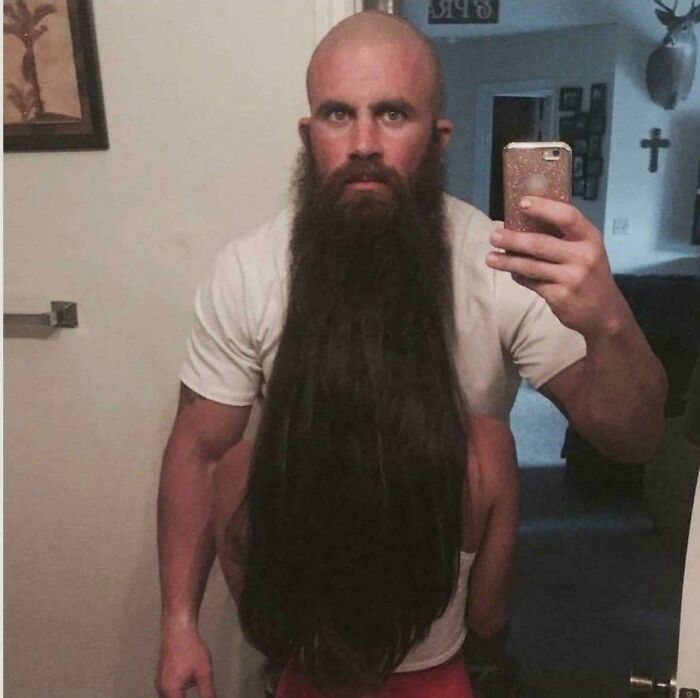Man with long beard disguising person behind creating eye confusing photo