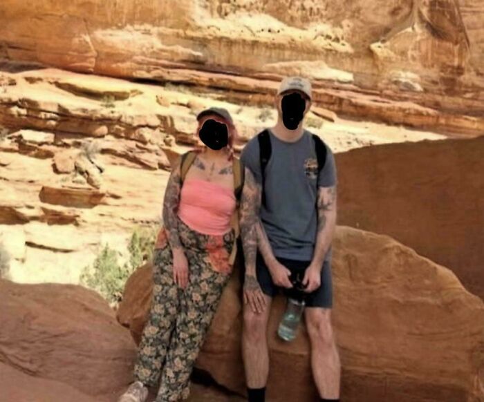 Couple posing on rock in desert scene with eye confusing photo effect