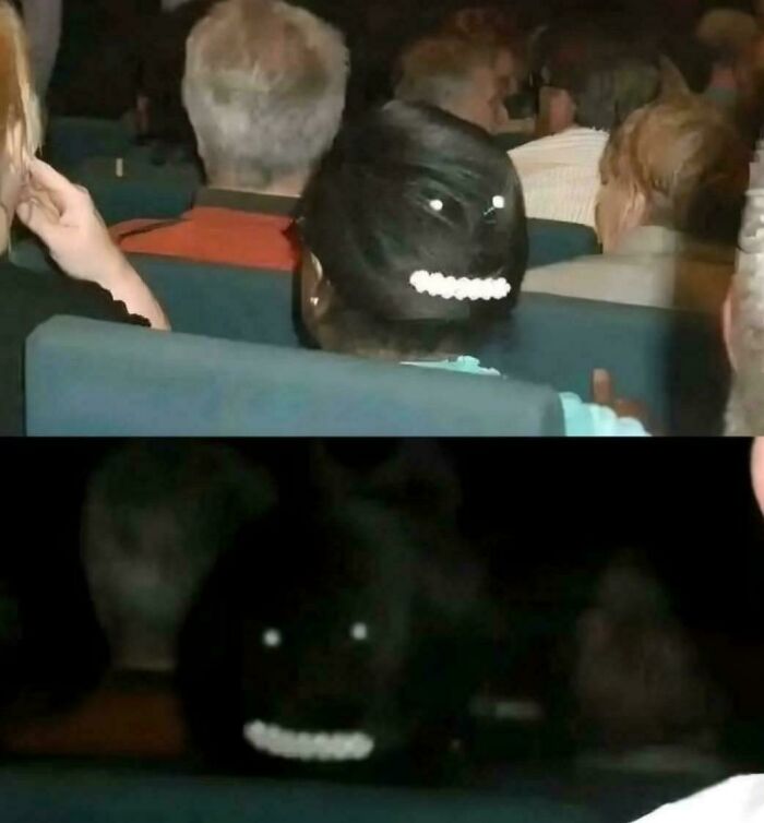 Dark photo showing a woman with hairpin creating glowing eyes and teeth illusion