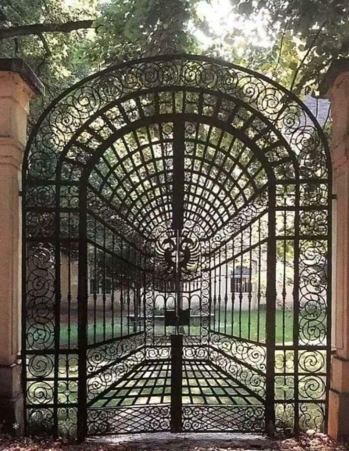 Iron gate with intricate design creating a 3D tunnel illusion confusing the eye