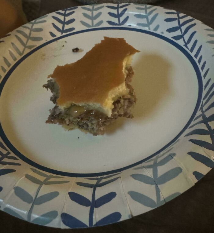 A partially eaten sandwich on a blue-patterned paper plate, illustrating funny things wives do