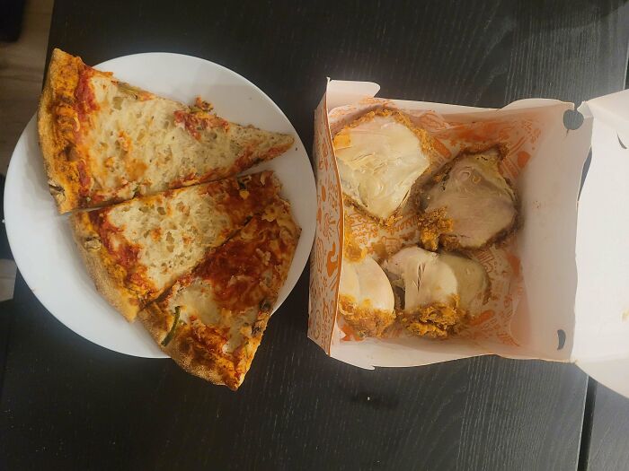 Leftovers of pizza and chicken on a plate, showing the funny things wives do