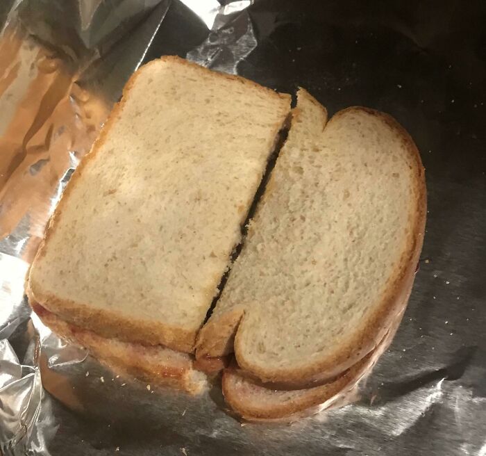 A sandwich cut in an odd, uneven shape, showing one of the ridiculous things wives do.