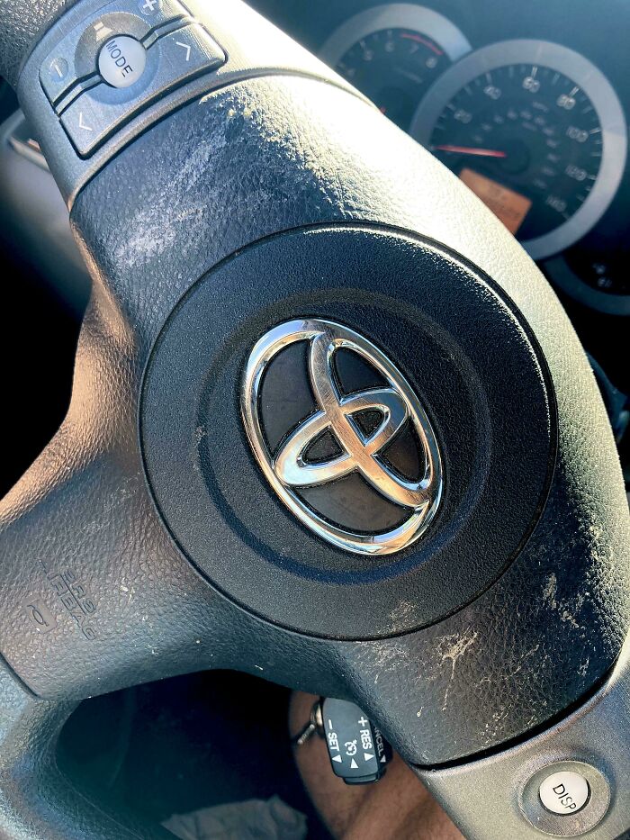 Dirty steering wheel showing sunscreen marks, depicting unhinged things wives do.