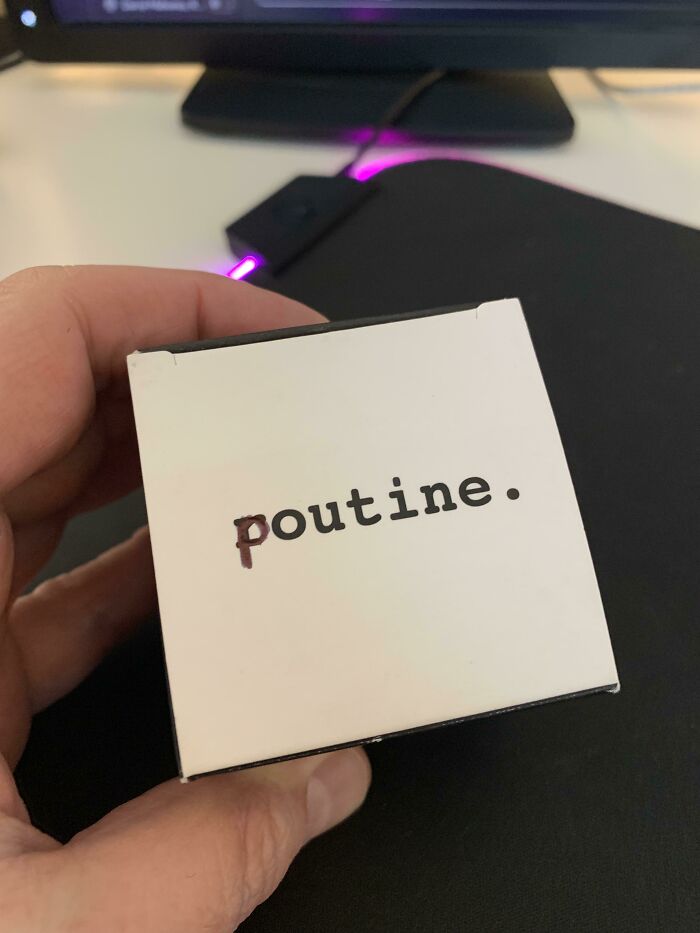 Hand holding a small white box that says poutine, showing funny things wives do