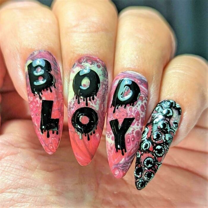 Nails painted to read bodily fluids out of order, representing hilarious badly designed signs with awkward layout.