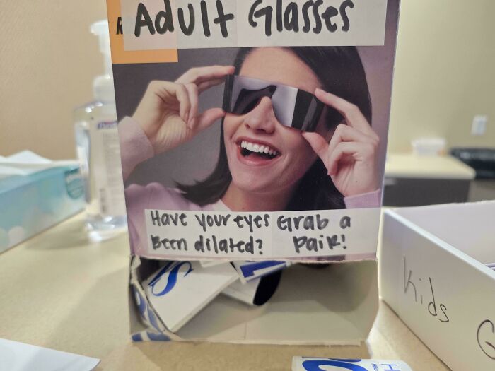 Eyewear display box with confusing handwritten text instructions, an example of hilarious badly designed signs.