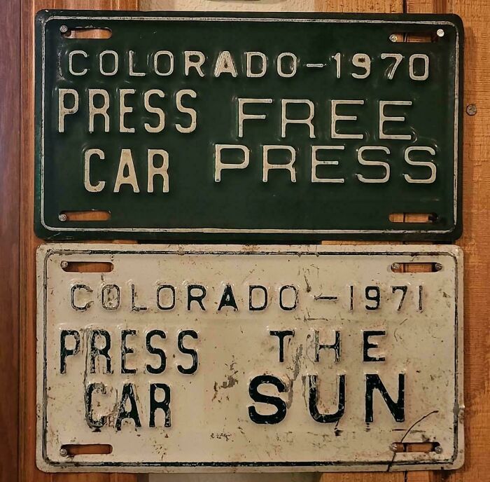 Vintage Colorado license plates with confusing text layout, serving as badly designed signs.