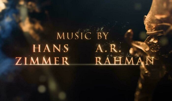 A movie screen credit displaying music by Hans Zimmer and A. R. Rahman showing badly designed text layout