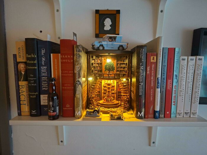 A glowing library book nook styled as a bookend on a shelf