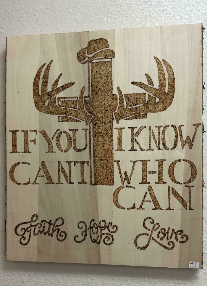 Wooden art piece with confusing layout text, serving as an example of a hilarious badly designed sign.