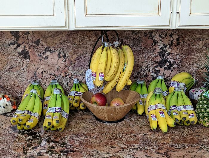 Countertop filled with dozens of banana bunches, illustrating the ridiculous things wives do.