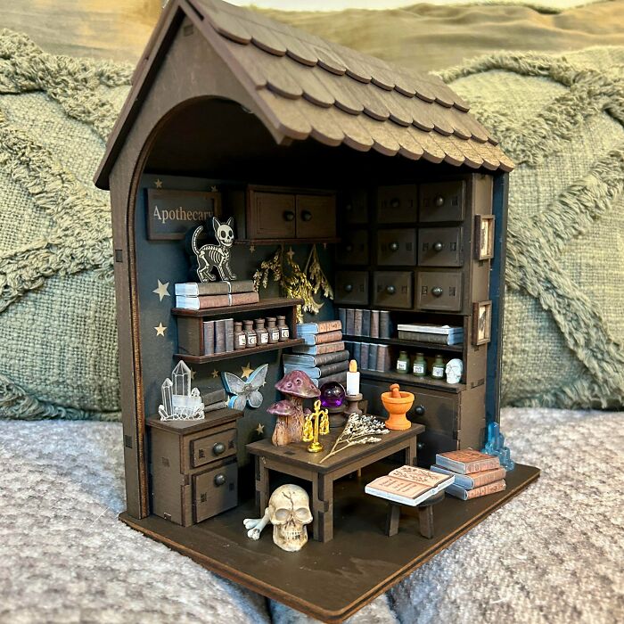 An apothecary shop themed miniature book nooks insert with tiny skulls, potions, and crystals