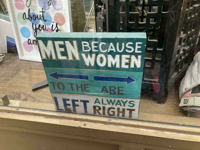 Hilarious badly designed wooden sign with confusing layout about men to the left and women always right.