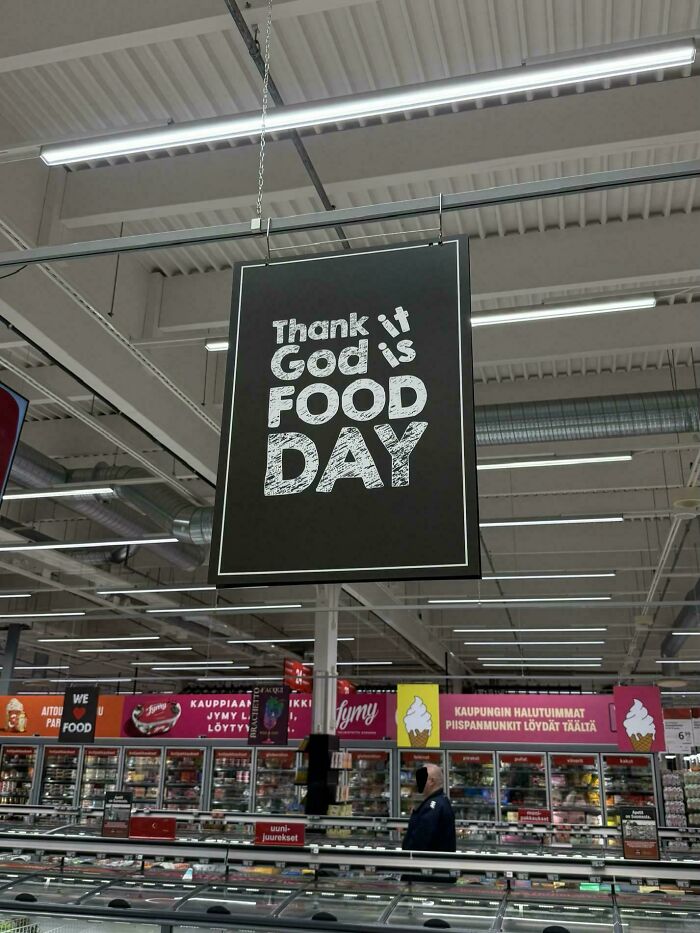 Grocery store hanging banner showcasing hilarious badly designed signs with jumbled text about food day.