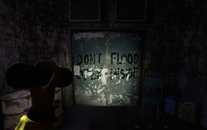 Dark room doors displaying badly designed signs with spray-painted text saying DONT FLOOD OPEN INSIDE.