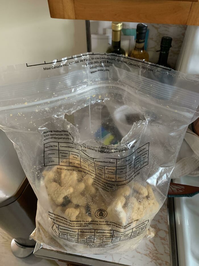 A bag of frozen food ripped open from the front instead of the zipper, showing funny things wives do