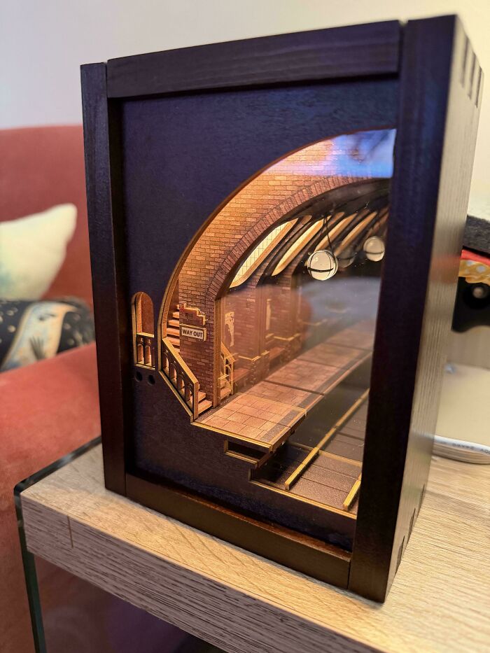 An elegant wooden book nook insert featuring a detailed miniature subway station platform with a Way Out sign.