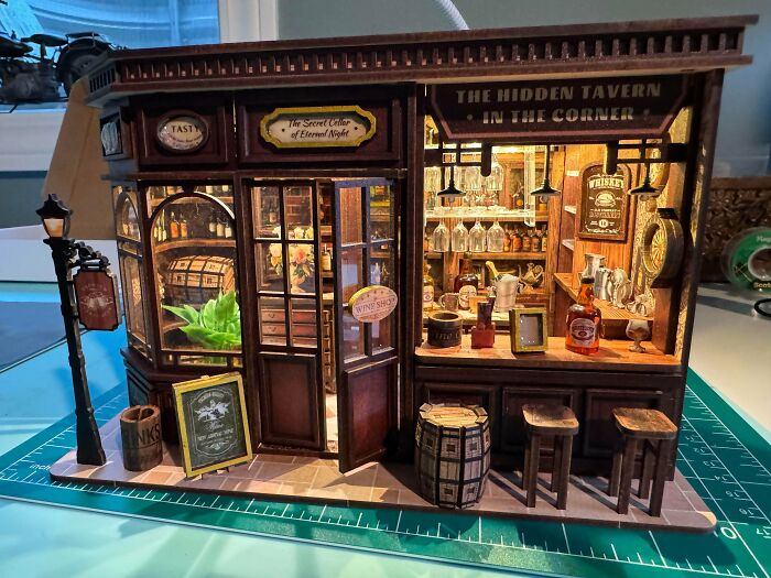 A highly detailed miniature tavern storefront designed as a unique book nook insert.