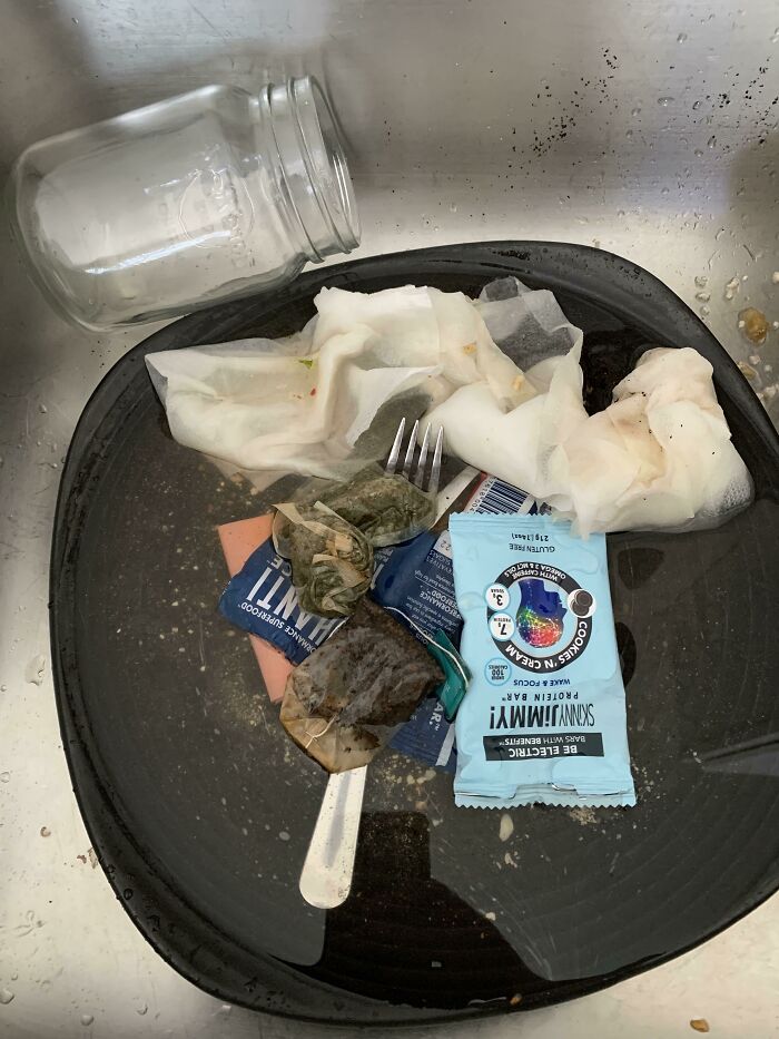 A sink filled with dirty dishes and tea bags, showing unhinged things wives do