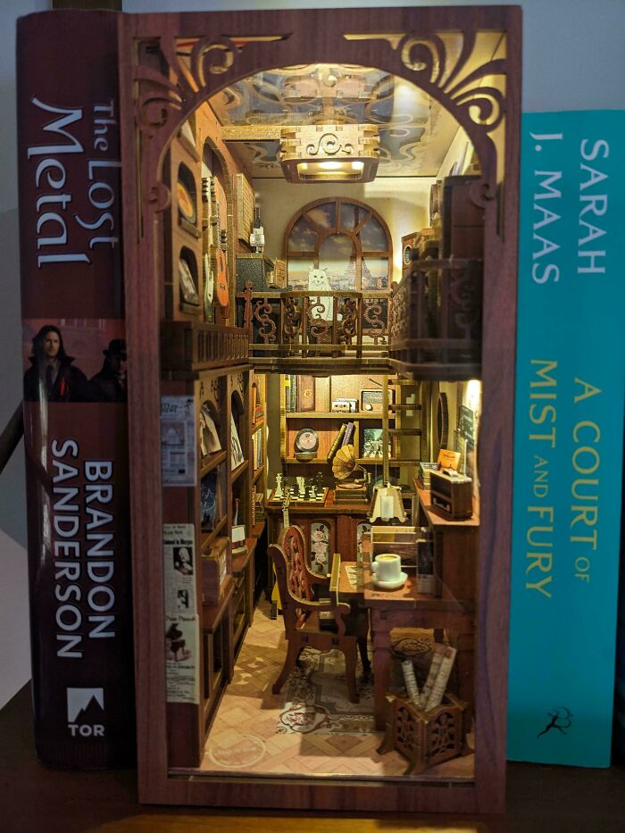 Cozy two-story study room model placed between books as book nooks