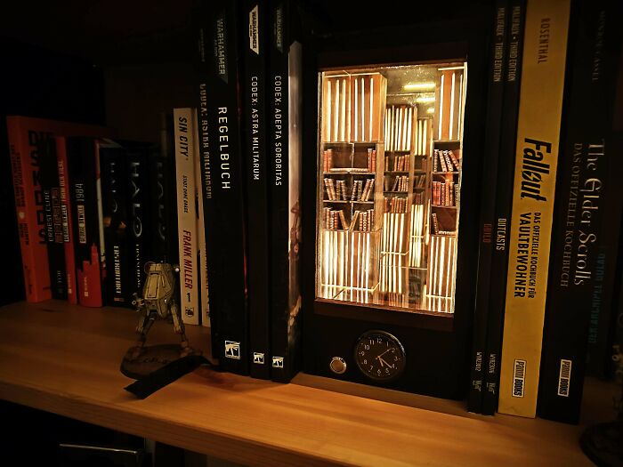A glowing library book nook inserted between real books on a shelf