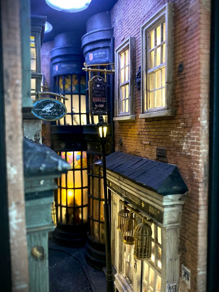 A magical alleyway book nook inspired by wizarding shops with glowing streetlights