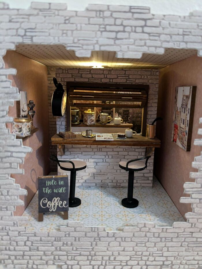 A detailed coffee shop book nook insert nestled between books
