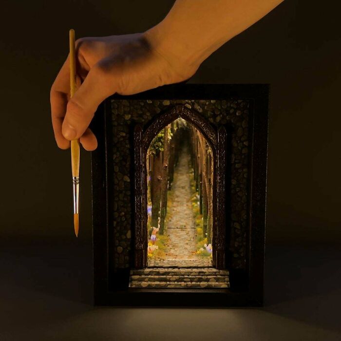 A handmade fantasy book nook with a long path through the woods