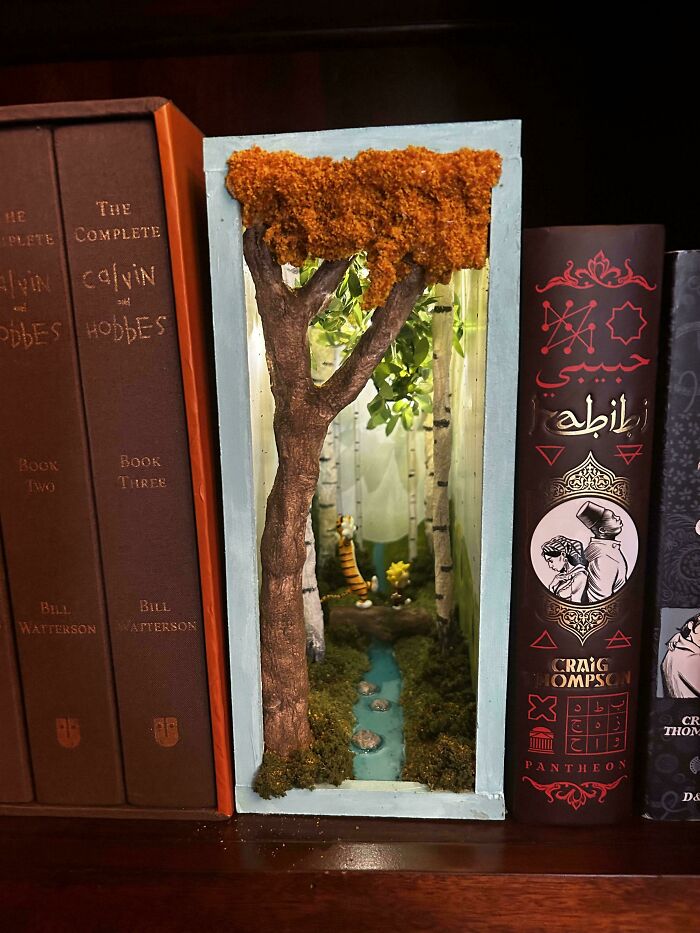 Calvin and Hobbes-inspired book nook miniature forest scene on a bookshelf