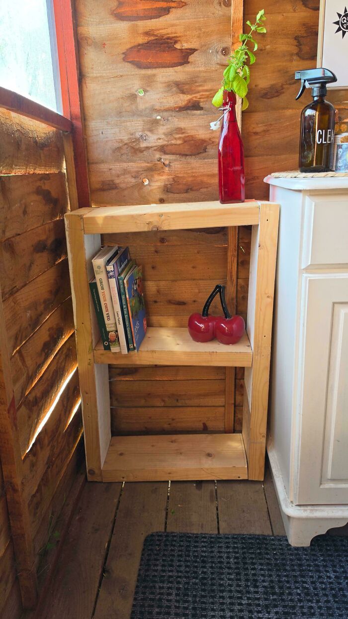 A simple handmade wooden shelf holding books as one of many functional DIY projects.