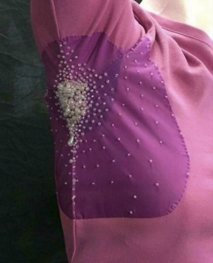 Pink shirt featuring a questionable DIY project with beaded fabric armpit patches.