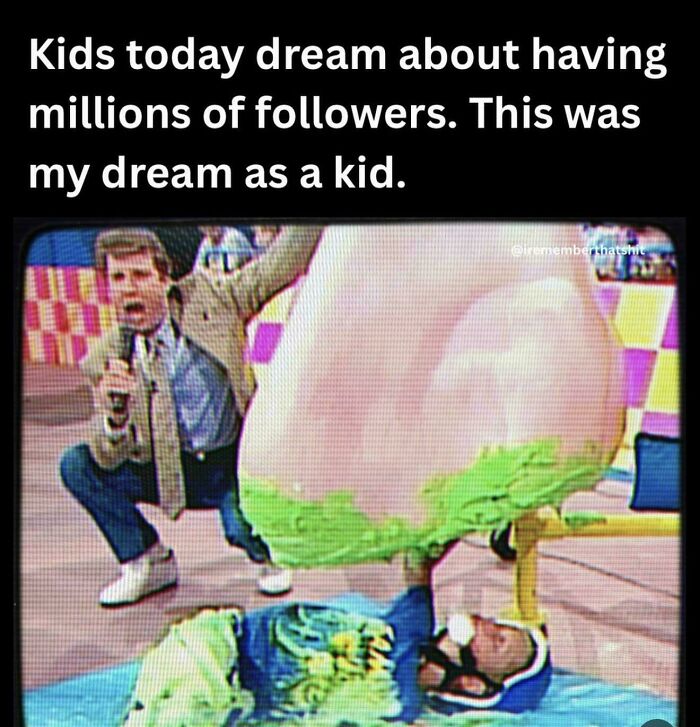 A contestant on a 90s TV game show picking a giant nose filled with green slime