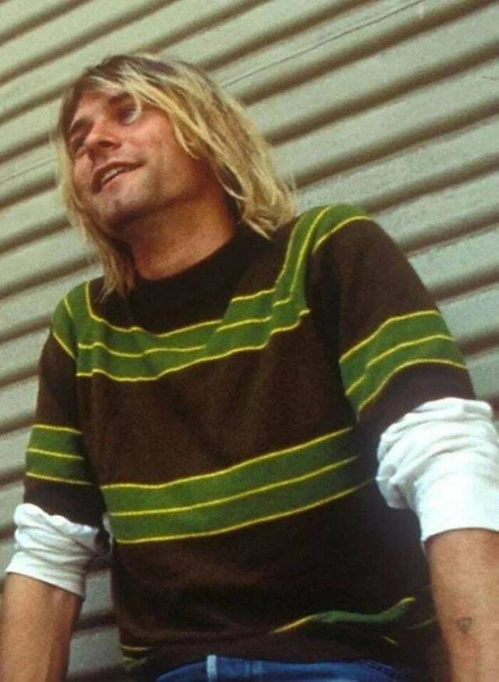 Kurt Cobain wearing his iconic striped sweater from the '90s