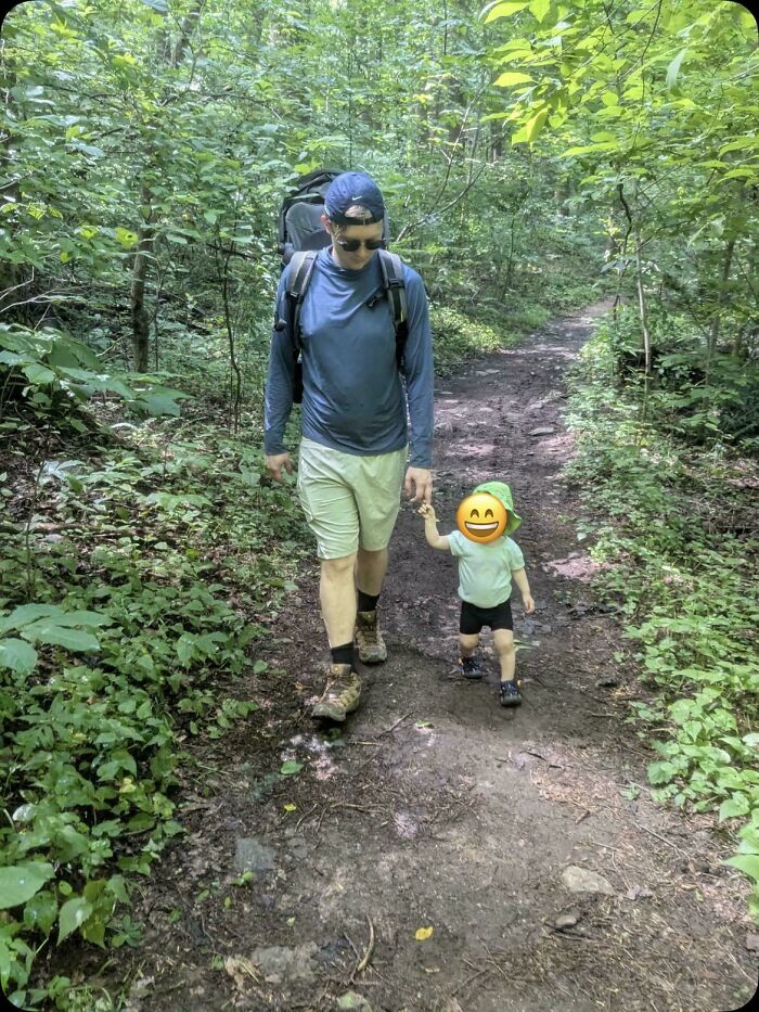 A father hiking with his young child on a trail, capturing wholesome pics of dads enjoying outdoor adventures.