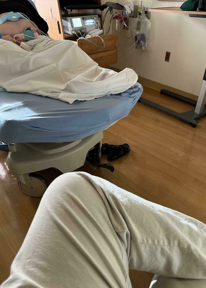 A dad waiting in a hospital room as a sign of wholesome fatherhood support during labor
