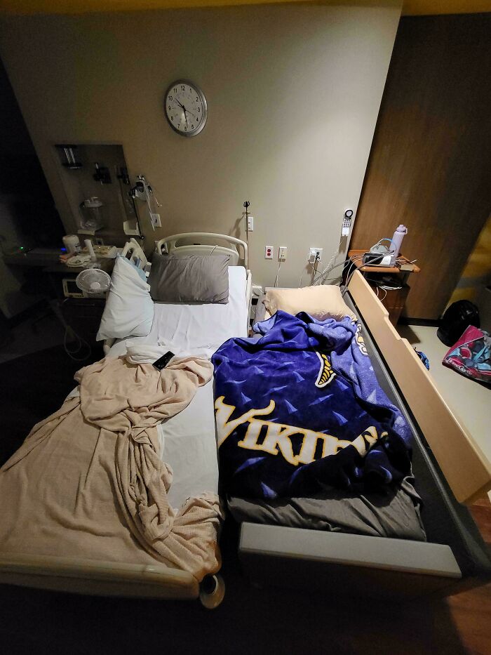 A hospital room setup showing a supportive dad staying near his partner in a wholesome fatherhood moment