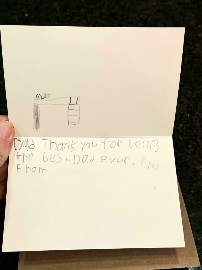 A handmade card with a drawing and message saying Dad thank you for being the best dad ever.