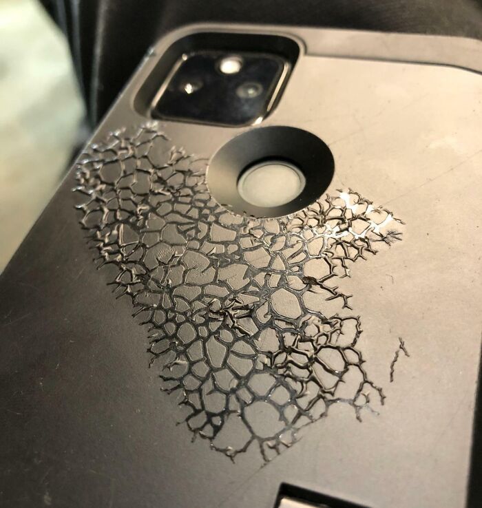 A black smartphone case showing a cracked pattern under heat in one of the interesting photos