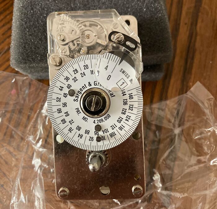 Interesting and cool photos of a mechanical timer on a wooden table